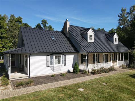 black house white metal roof|black metal roof house pictures.